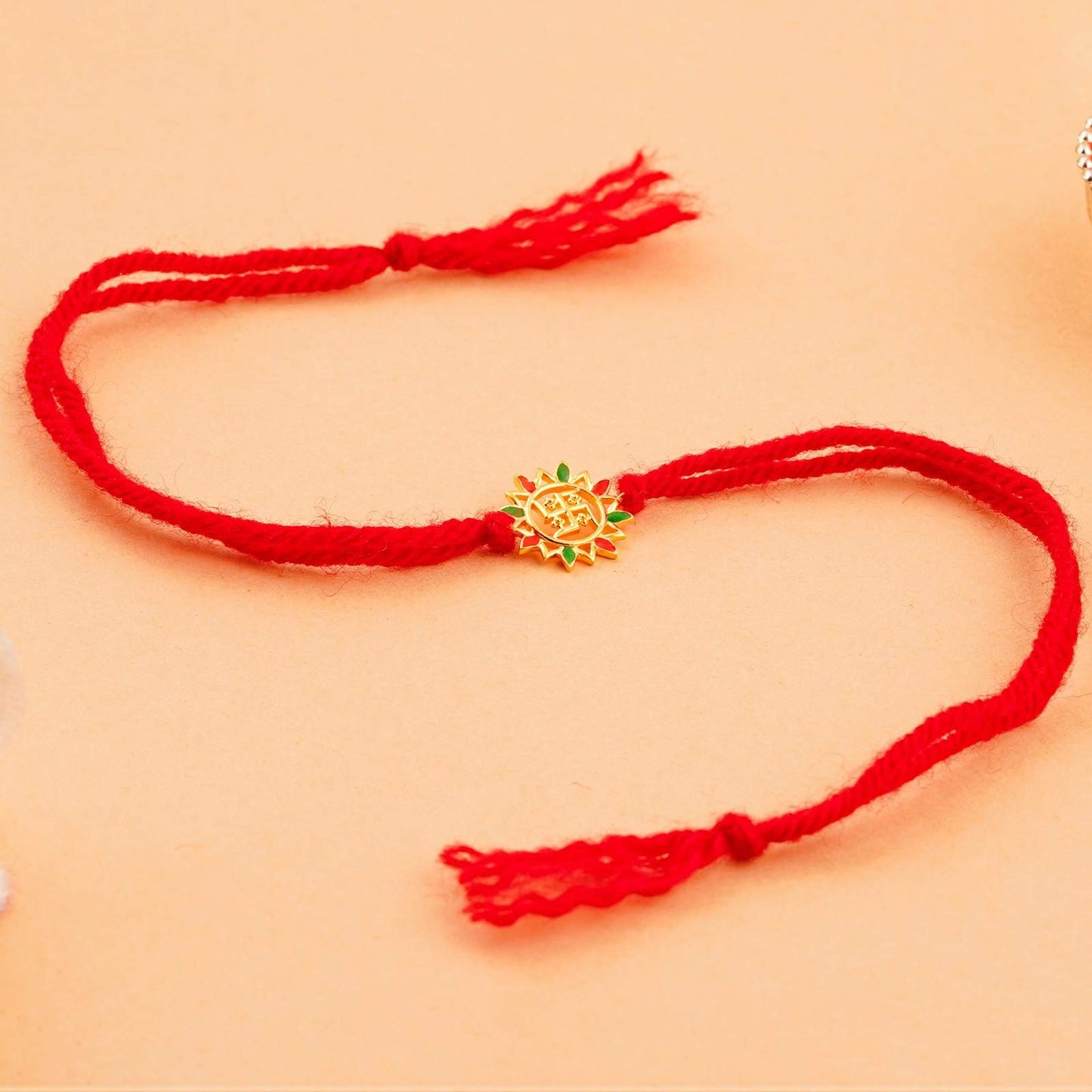Silver Rakhi: Golden Swastik Enamel Rakhi For Kids